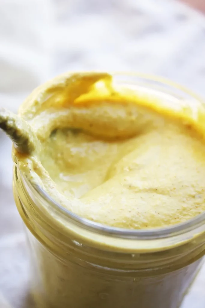 A bowl of creamy curry dip on a table