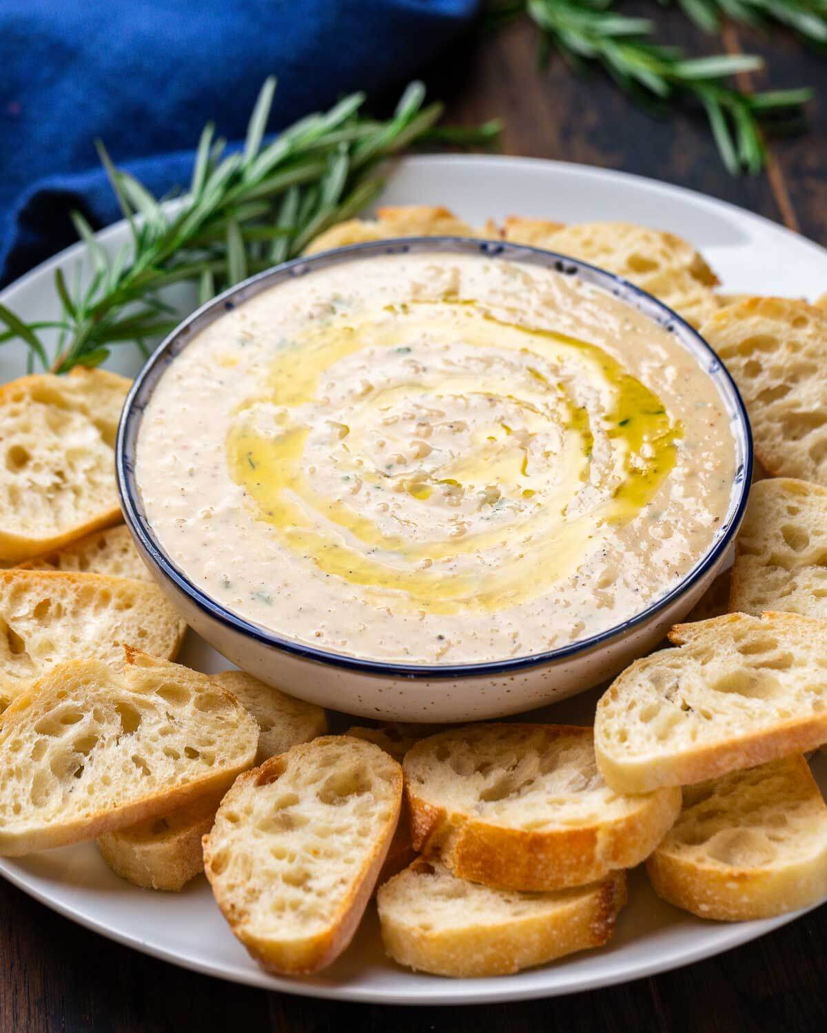 Cannellini bean dip with crostini on a plate