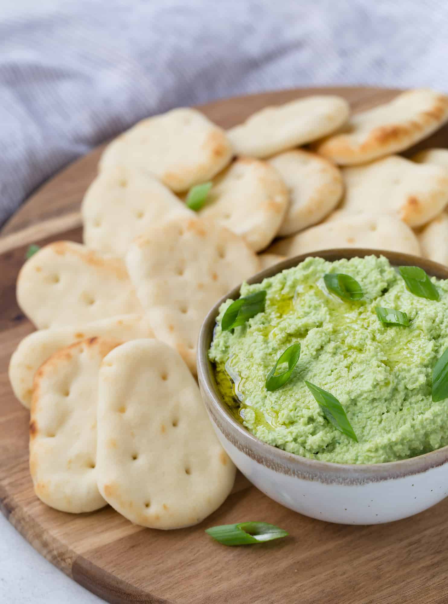 Edamame dip and crackers on a plate
